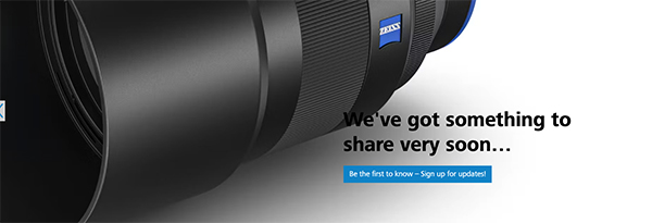 This is an image of the lower page of a Zeiss camera lens, with the words "we've got something to share very soon..."