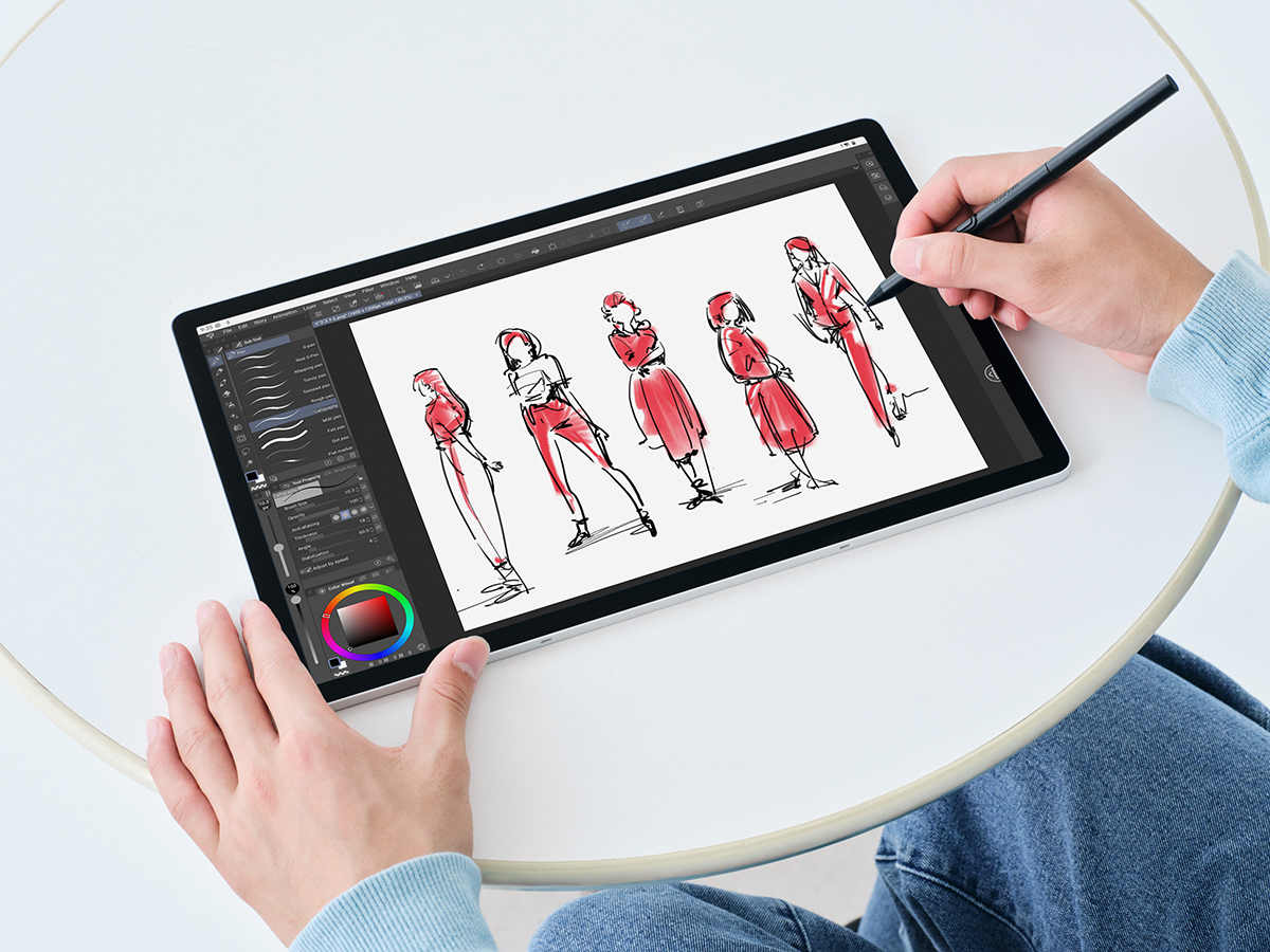 This is someone drawing several figures on the Wacom MovinkPad Pro 14 portable creative pad using the Pro Pen 3 set against a white background.