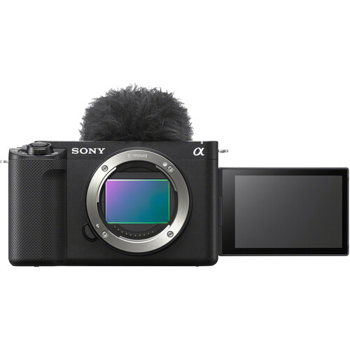 Front view of the Sony ZV-E1 mirrorless camera with flip-out LCD screen and attached windscreen, showing the exposed sensor.