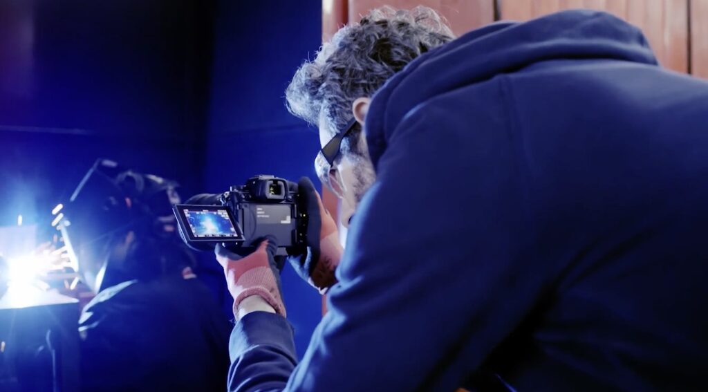 The Nikon Z6 III being used to film a welder working on a project.