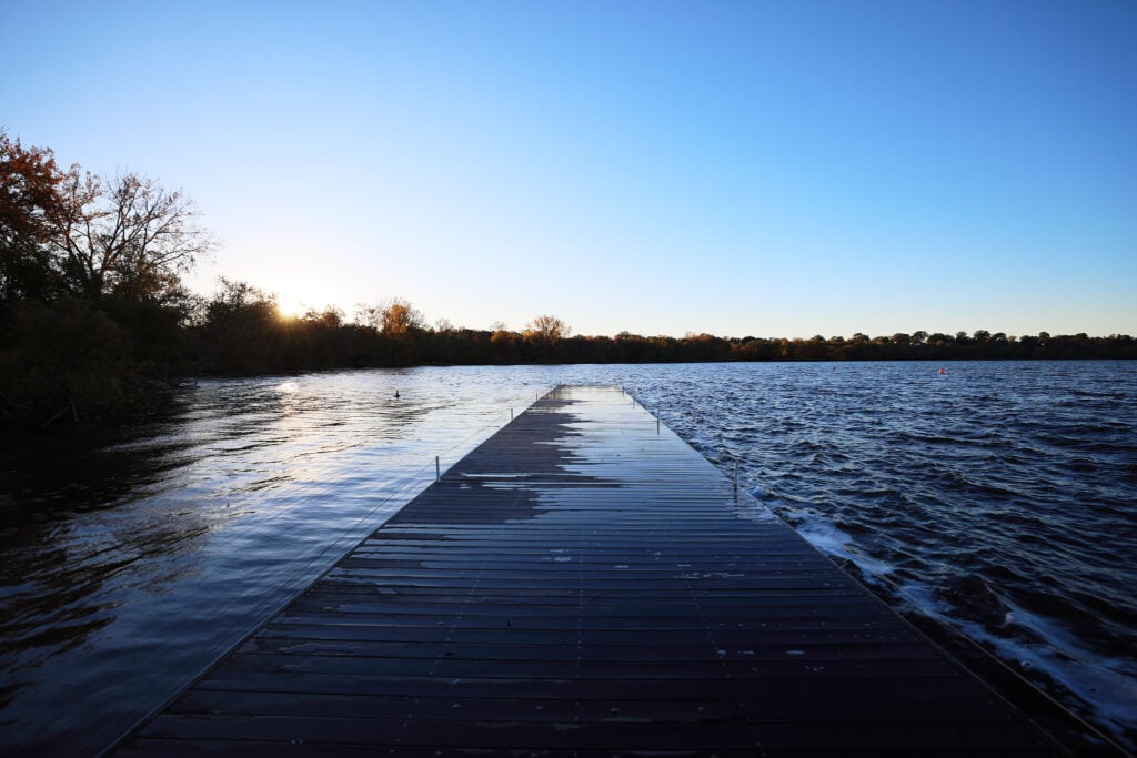 A dock justs out into a lake