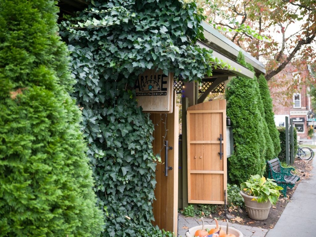 A cafe with entracnce covered in vines