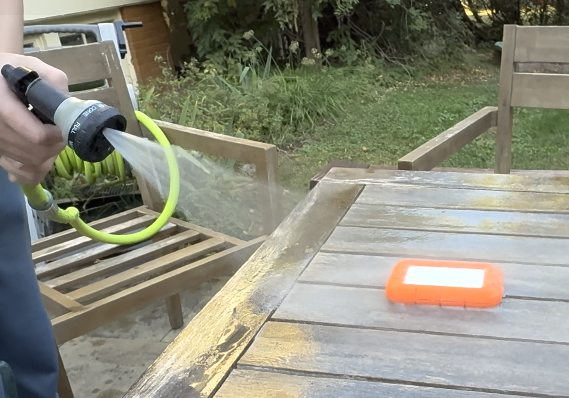 Spraying the LaCie Rugged SSD4 with water from a hose. 