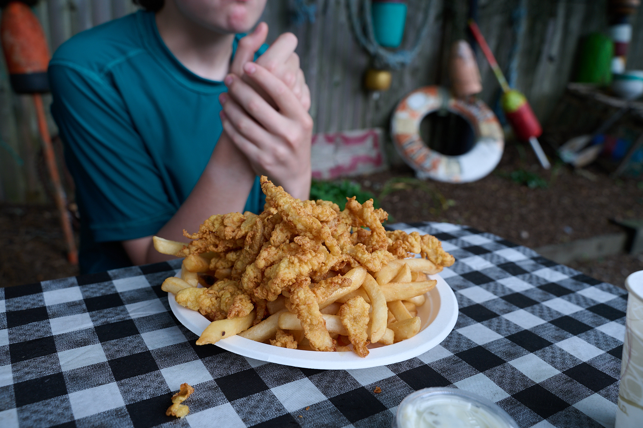 A plate of fried clams and french fries.