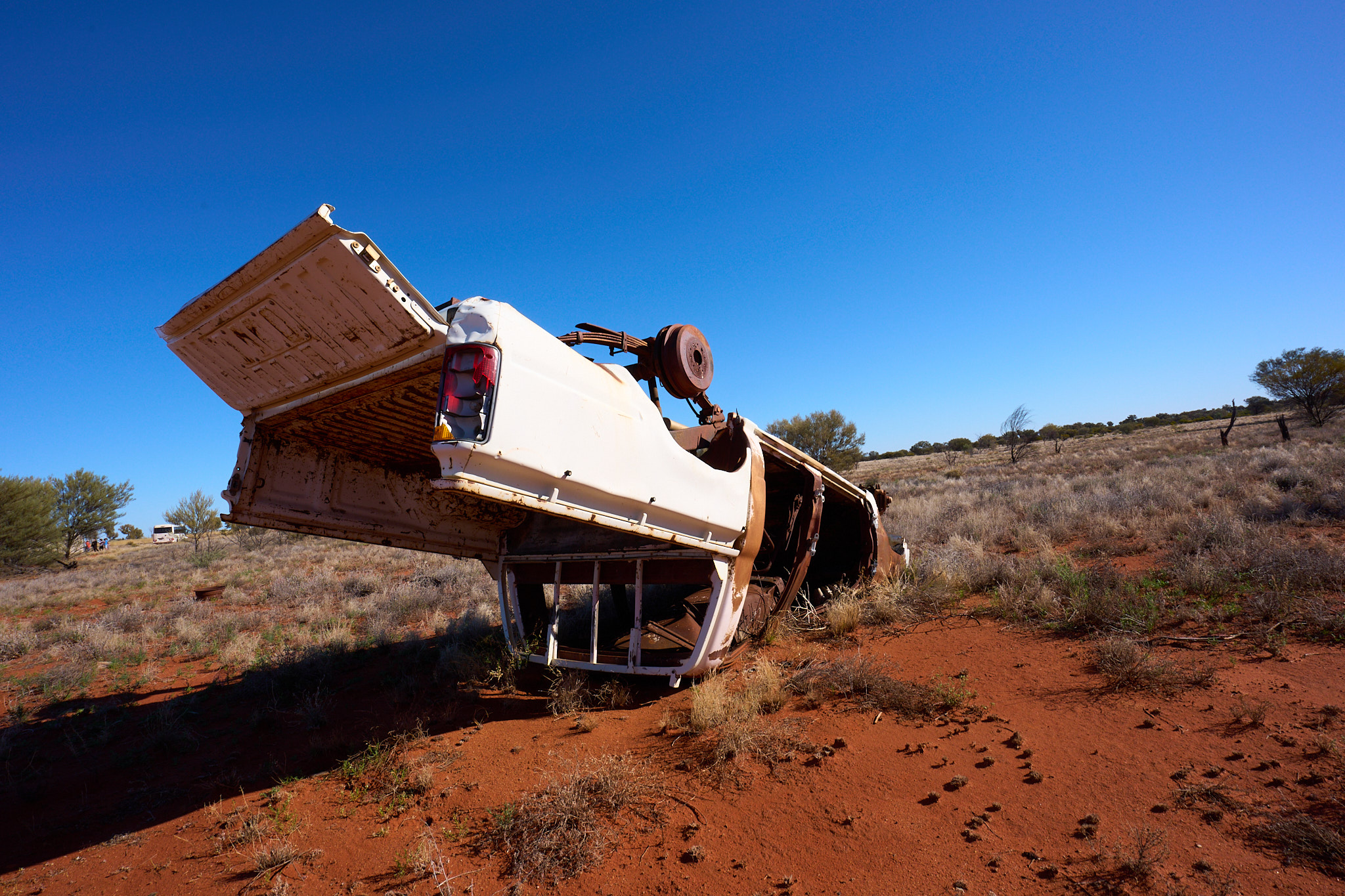 An overturned vehicle in the Australian desert.