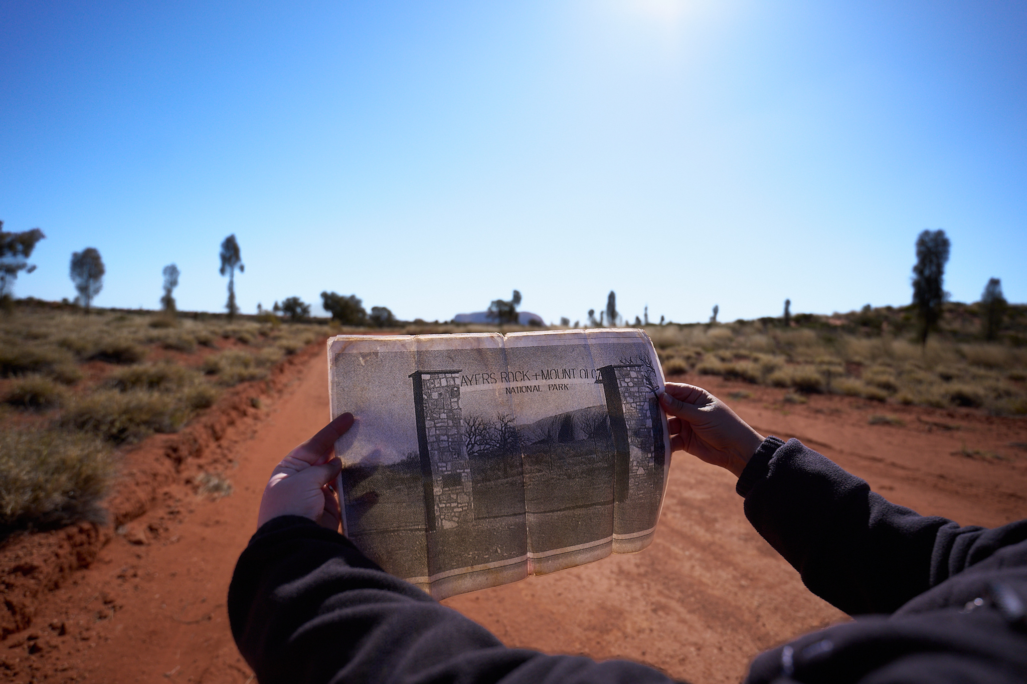 A tour guide shows the newspaper ad for a resort that resided on indigenous lands.